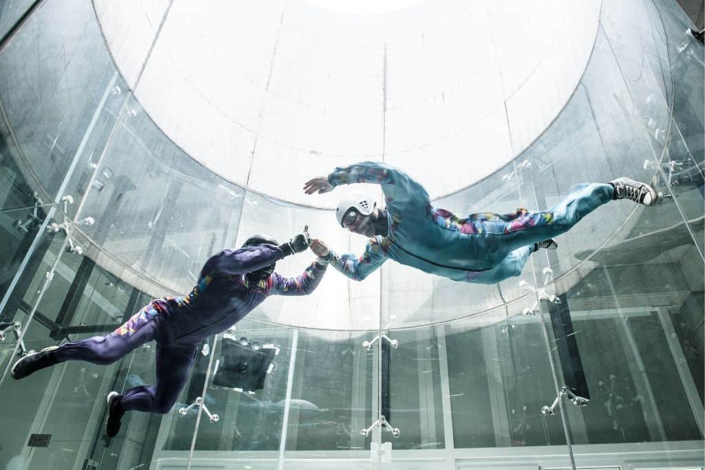 People indoor skydiving