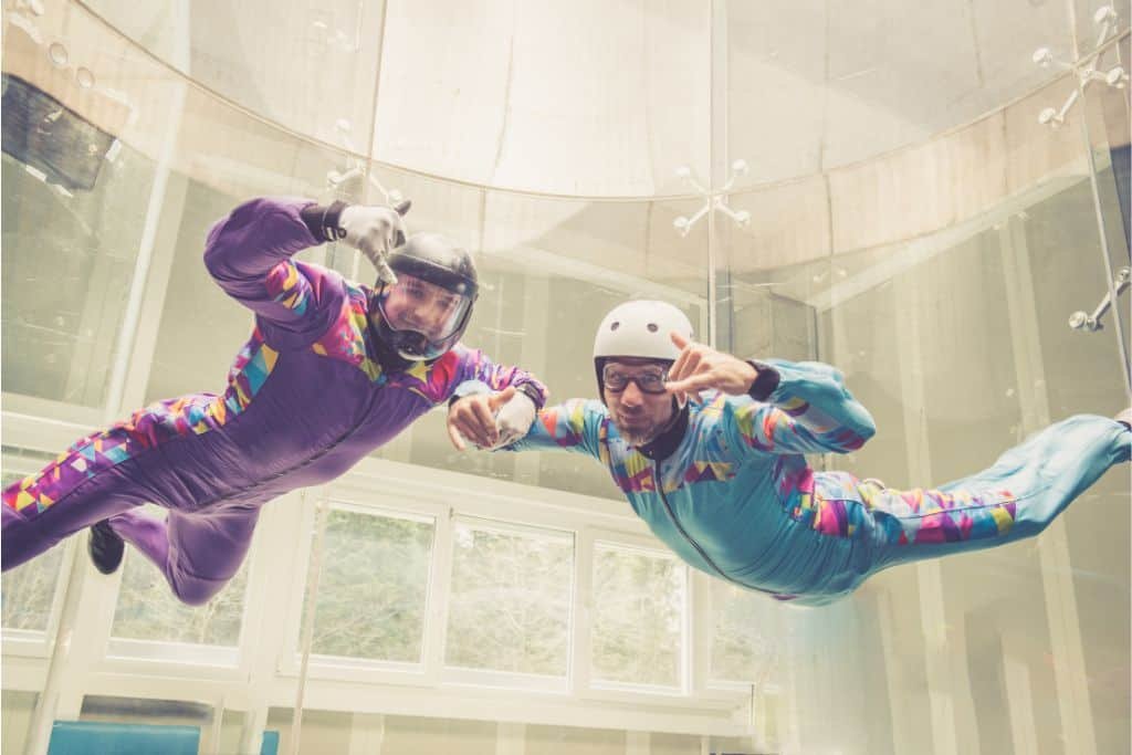 People indoor skydiving