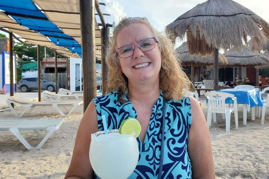 Sherry drinking a margarita in Chicxulub Puerto, Mexico.