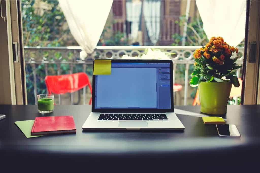 A laptop in front of a window