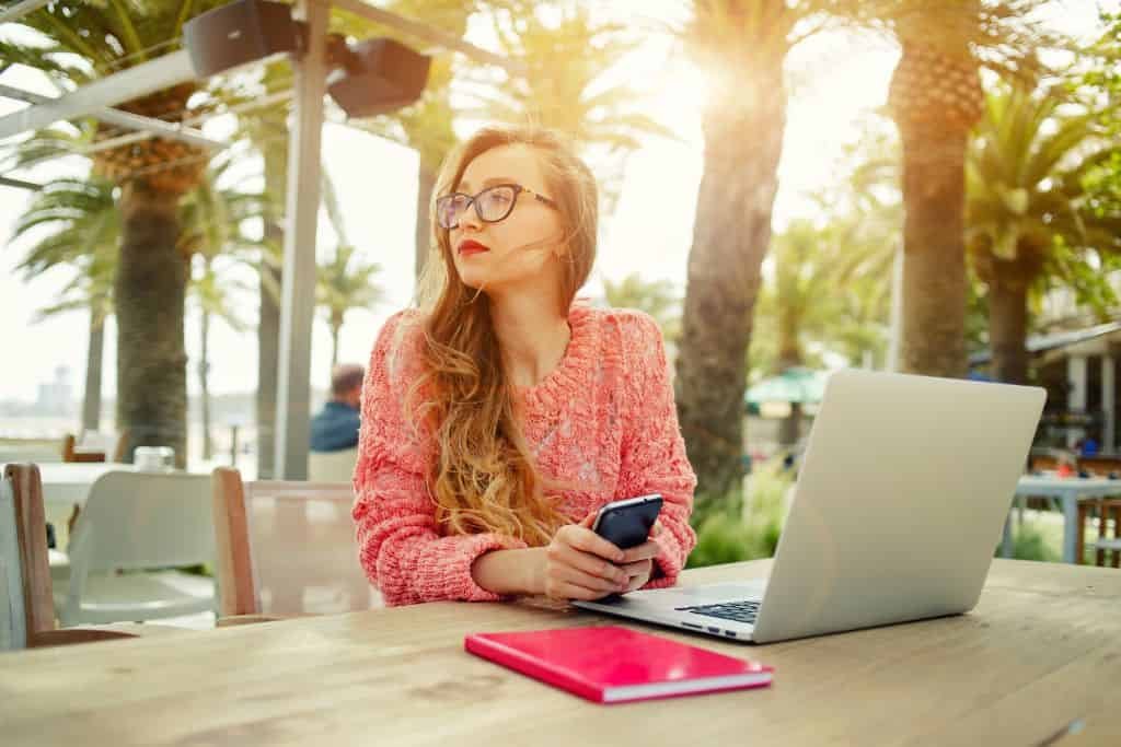 A woman working on a laptop outside