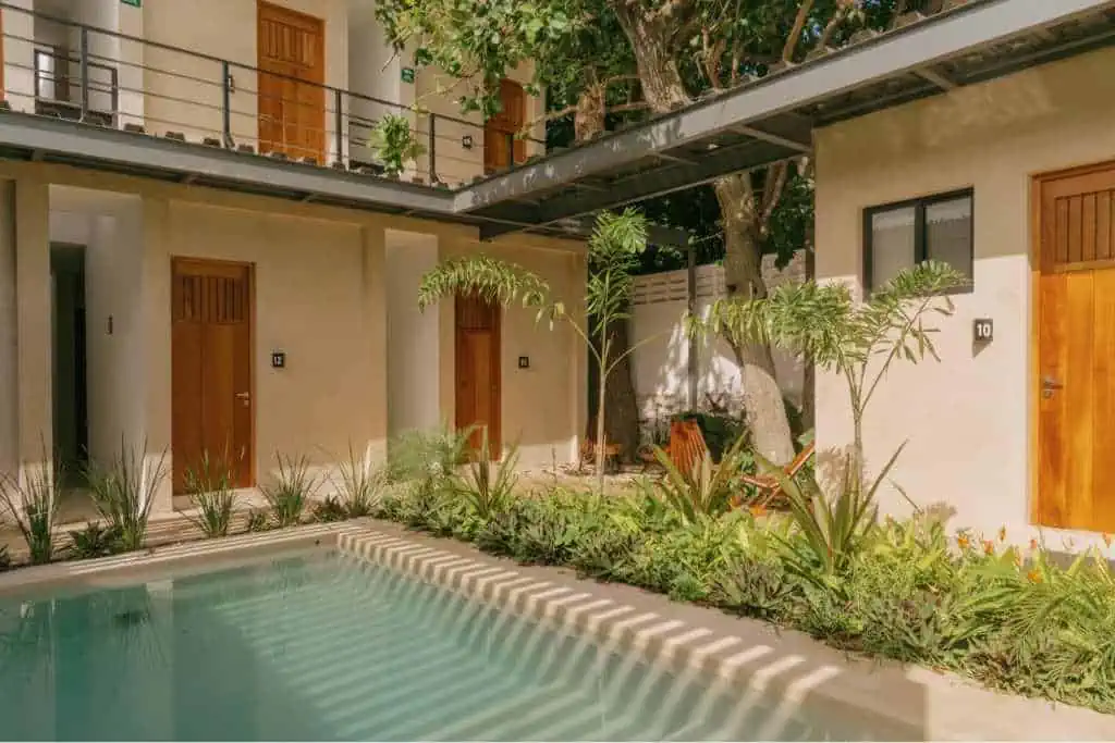 A swimming pool surrounded by apartments and trees.