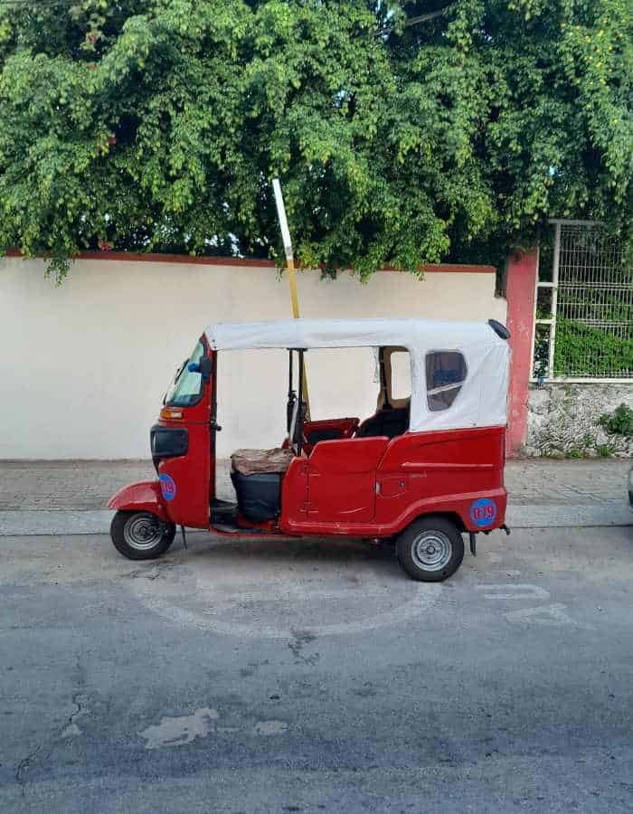 A red and white mototaxi in Cozumel