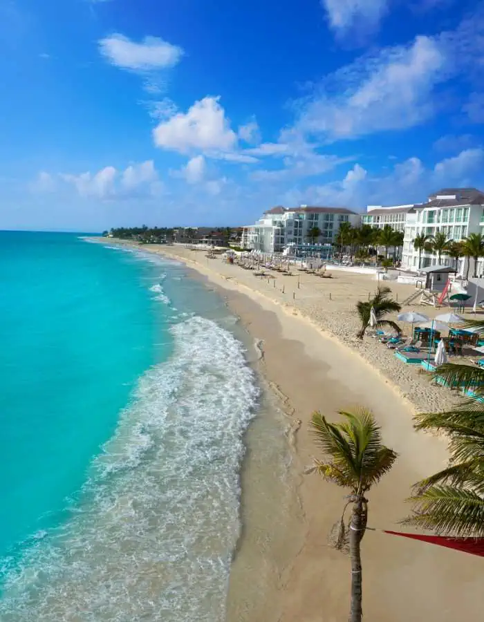 Long sandy beach with hotels facing the Caribbean Sea.