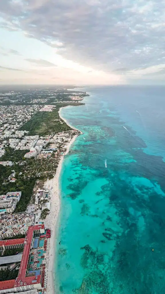 Drone captures the vibrant turquoise waters and beaches of Playa del Carmen, Mexico.